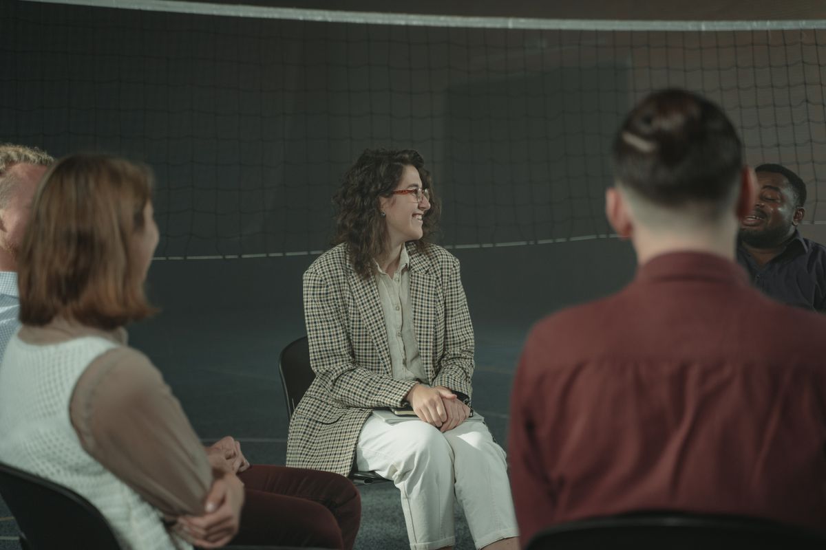 People sharing their experiences in a facilitated conversation circle
