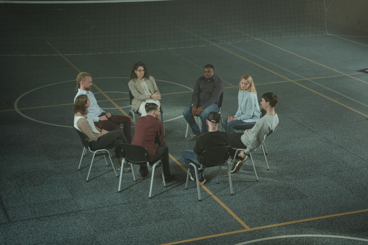Community members seated together in a supportive group